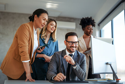 Group of young business people working as a team and communicating in corporate office