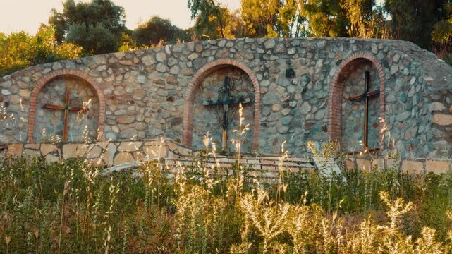 Three sacred Christian religious crucifixes in an Italian outdoor Calvary
