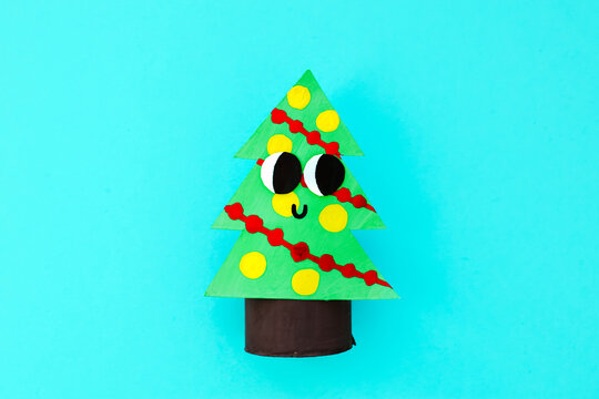Christmas toy from toilet tube roll, paper toy santa claus, snowman, reindeer, tree rabbit on yellow background. Holiday easy kids DIY, decoration idea for winter season, home party. Children's crafts