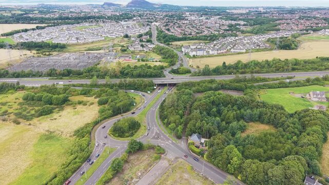 Aerial view of road junction network and highway bypass near Straiton in Edinburgh, Scotland