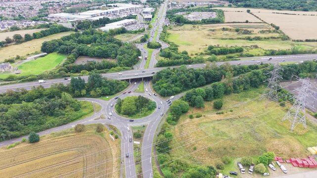 Aerial view of busy roundabout and highway interchange network at Straiton Junction in Edinburgh, Scotland