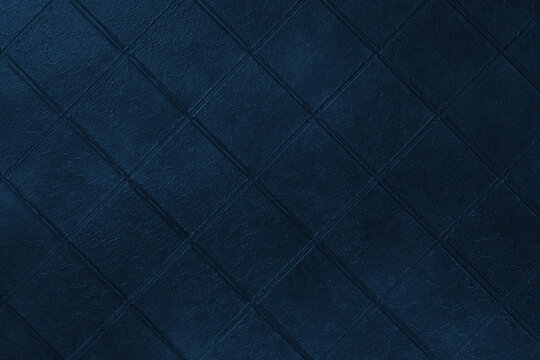 Dark blue ceramic tile texture background with diamond diagonal square pattern, grunge surface. Abstract geometric wall backdrop with textured tiles, copy space. Interior element, vintage design
