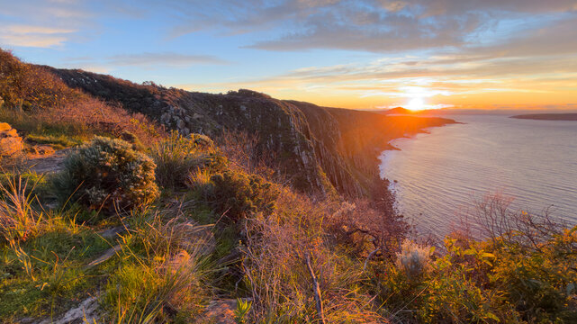 Epic sunrise golden light on the Waitpinga Cliffs at dawn over the ocean and horizon on the Fleurieu Peninsula in South Australia