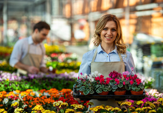 Female Gardener Carrying Flowers.