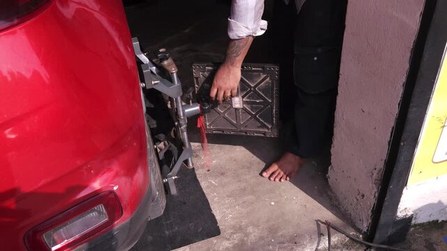 Professional Mechanic Performing Car Wheel Balancing Service in Automotive Workshop, Tire and Wheel Balancing Equipment, Vehicle Maintenance, Auto Repair, Garage Service and Road Safety