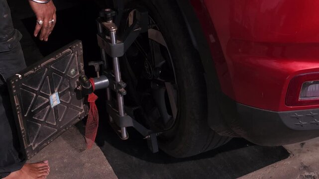 Professional Mechanic Performing Car Wheel Balancing Service in Automotive Workshop, Tire and Wheel Balancing Equipment, Vehicle Maintenance, Auto Repair, Garage Service and Road Safety