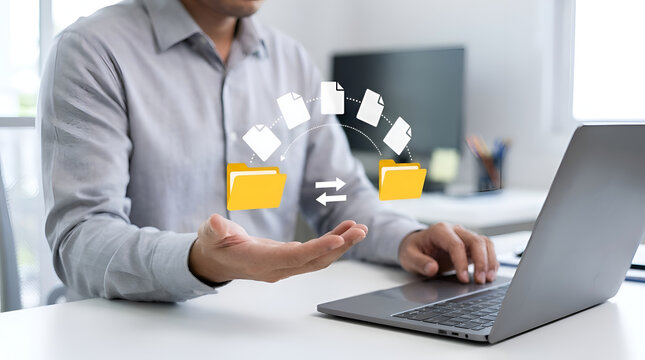 Businessman manages digital file transfer between folders above a desk with a laptop.