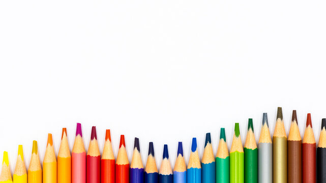 Colorful colored pencils arranged along a white background