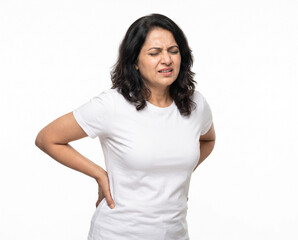 Fototapeta premium Middle aged Indian woman holding both hands on her lower back while experiencing severe lumbar pain for physiotherapy chiropractic orthopedic healthcare and pain management
