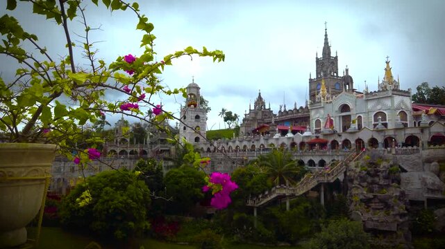 Simala Shrine - Cathedral Towers and Flower - Catholic Church and Monastery of Holy Eucharist in Sibonga Village - Cebu City Region - Philippines Landmarks - Cloudy Day - LS CU 4K UHD