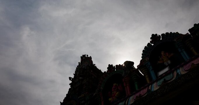 Sunrise over temple in the city captured in four frames showing clouds and structure at morning time