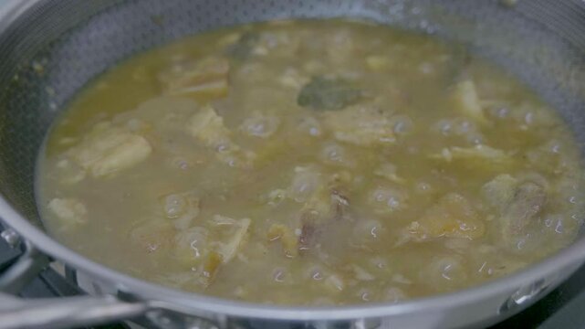 Filipino Lechon Paksiw cooking process in a kitchen