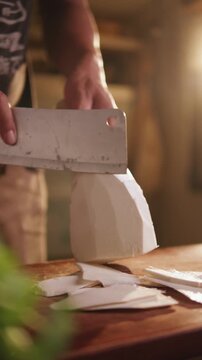 Close-up of slicing bamboo shoots on a wooden cutting board.