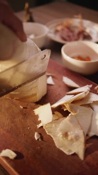 Close-up of slicing bamboo shoots on a wooden cutting board.