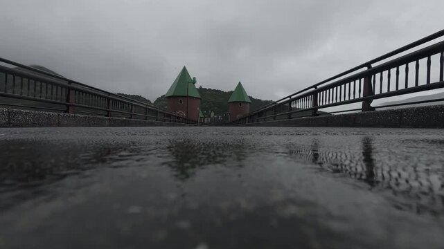 Cinematic Low Angle Symmetrical Bridge Reflection in Rain 4K B-Roll