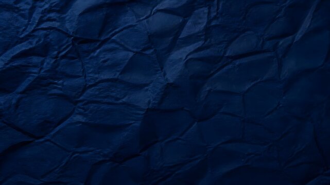Dark blue crumpled paper texture surface background with creased folds and subtle shadows crumpled background wrinkled abstract