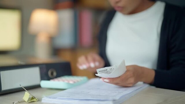 Businesswoman Reviewing Receipts and Calculating Office Expenses