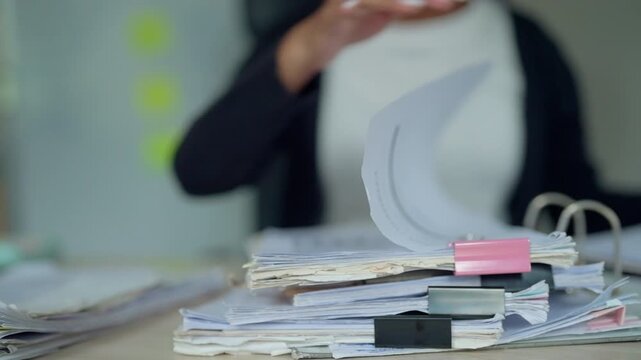 Office Worker Sorting Business Documents into Clipboard for Record Management