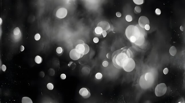 Monochrome black and white abstract bokeh background with glowing light spots and dark blurry texture background monochrome abstract