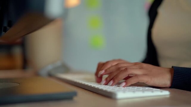 Businesswoman Typing on Computer Keyboard at Modern Office Desk