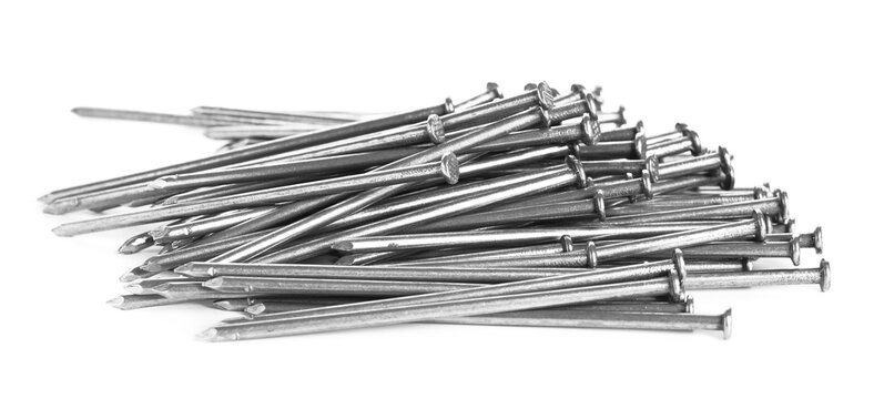Many shiny metal nails isolated on white