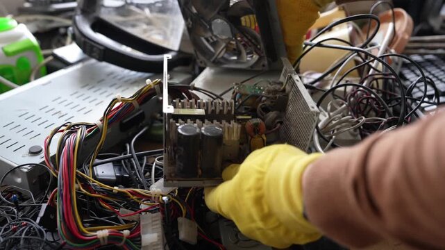 E-waste recycling in developing country landfill, dismantling old electronics, unsafe conditions, scrap devices, toxic materials, manual labor, poverty, technology repair