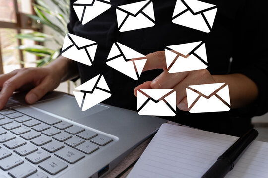 Workplace scene with hands on keyboard and email symbols