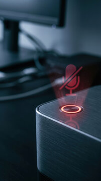 Microphone mute button on desktop ai hacking voice control with dark metal device in office