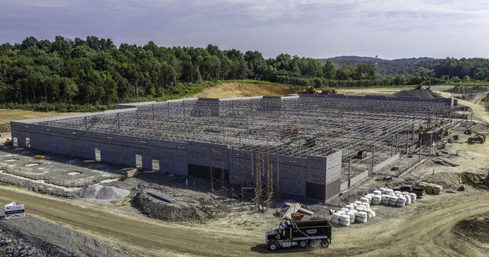 Aerial view of a new industrial warehouse distribution facility under construction with steel framing and concrete walls at a site in Mt. Juliet, Tennessee, United States.