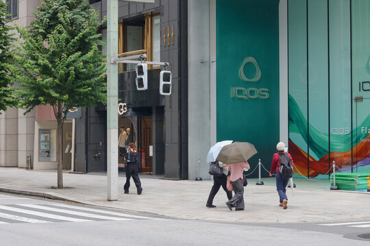 TOKYO, JAPAN - August 16, 2026: Main street in Ginza with a soon-to-open Iqos flagship store and an UGG store.