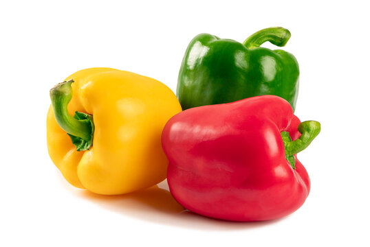 Vibrant group of three fresh organic bell peppers in red, yellow, and green colors isolated on white background studio shot perfect for healthy cooking, nutrition, and fresh produce concepts.