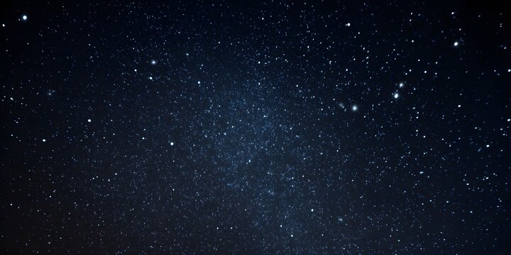 Dense field of countless stars scattered across the dark expanse of the night sky with faint nebula textures visible