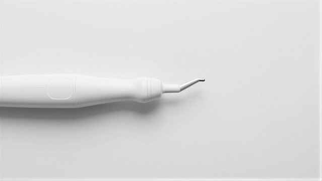 White medical device with sleek design and fine needle tip on minimalist background.