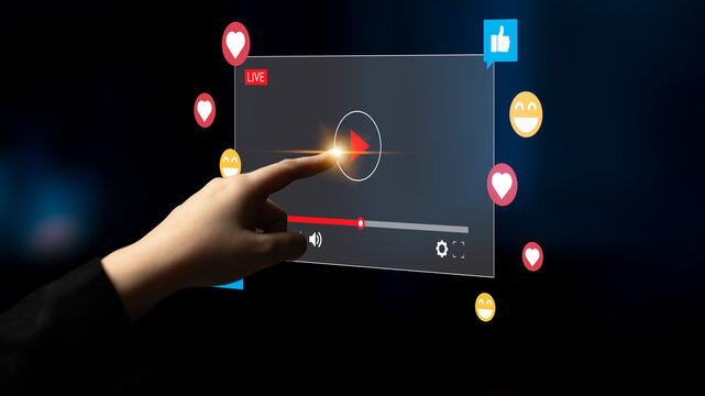 A hand reaches toward an interactive video screen showcasing a live broadcast with various social media reactions represented through colorful icons and graphics. Ledger