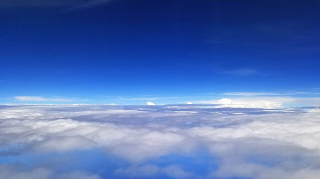 Aerial View Above White Cloudscape and Blue Sky Horizon