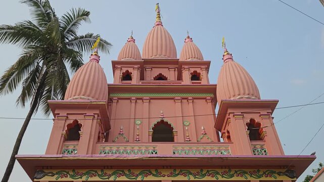 Sri Gopinath Gaudiya Math Temple in Mayapur, West Bengal, India, Peach-Colored Hindu Temple Facade with Ornate Domes and Traditional Architecture, Spiritual Pilgrimage and Religious Heritage