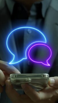Businessman using smartphone vertical shot displaying glowing double speech bubbles message frame overlay display. Social media chat conversation, customer testimonial review, and dialogue concept.