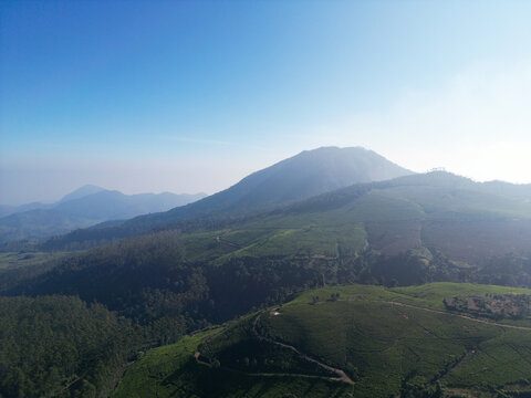 Aerial View of Hazy Volcano Above Highland Tea Plantations