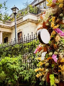 Luxury floral entrance whith blank round sign on vintage mansion fance 