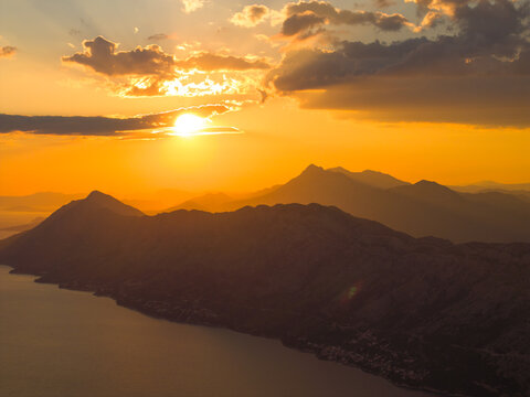 Aerial view of the sunset over the coastal mountains and the Adriatic Sea in Brela, Split-Dalmatia County, Croatia.
