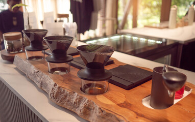 Fototapeta premium Professional bar tools and jiggers on stainless steel drip tray at coffee bar counter.