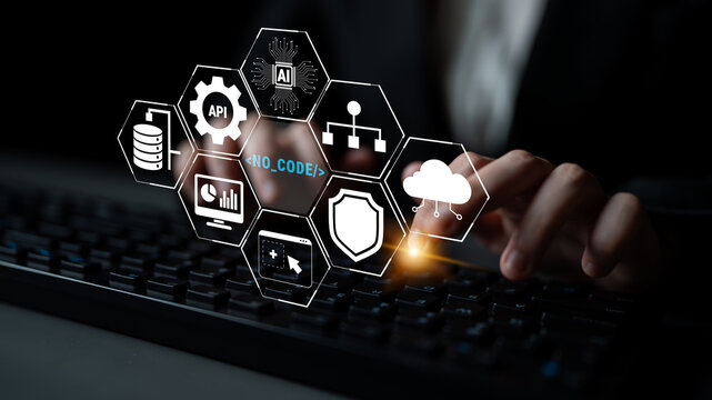 Business professional engaging in no-code development solutions while using a keyboard with futuristic technology icons and digital interface graphics in focus. Quark.