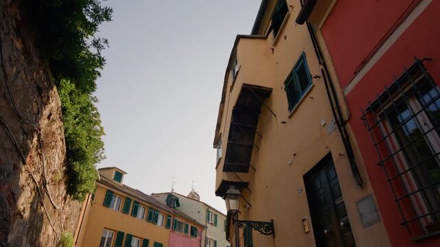Colorful traditional houses line a narrow street in the Boccadasse district, Genoa