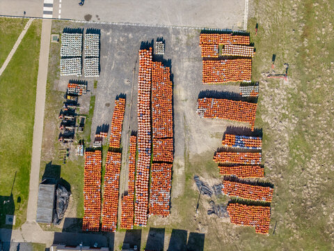Aerial view of Kleinvlei storage yard filled with rows of orange gas cylinders and containers in Cape Town, Western Cape, South Africa.