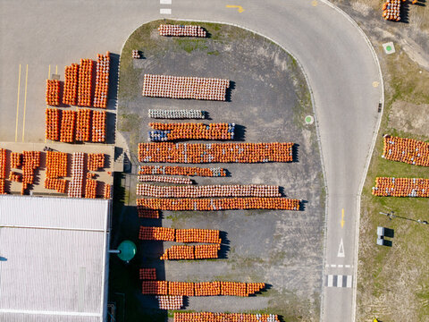 Aerial view of rows of orange gas cylinders stored in an industrial yard in Kleinvlei, Cape Town, Western Cape, South Africa.