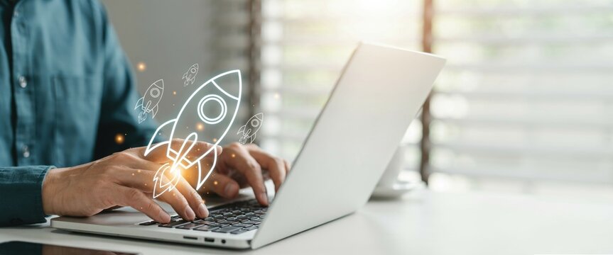 Business professional using laptop with digital rocket icon