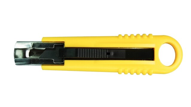 Paper cutter and other miscellaneous items isolated on white background horizontal position. Side view of yellow utility knife