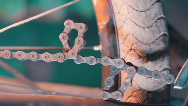 Rusty Bicycle Chain with Kinked Link: Side Tracking Shot | Old Metal Chain Detail Near Tire in Slow Motion | Worn Bike Mechanism Macro