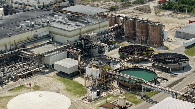 Aerial view of Smurfit Westrock Seminole Mill featuring industrial processing tanks, large water treatment basins, and complex piping infrastructure in Jacksonville, Florida, United States.