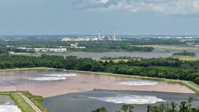 Aerial view of the Smurfit Westrock Seminole Mill with industrial facilities and large wastewater treatment ponds surrounded by lush green vegetation in Jacksonville, Florida, United States.
